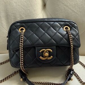 CHANEL Black Quilted Bag with Gold Accents